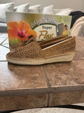 Never worn Easy Street espadrilles.  Tan in color with zipper accent.